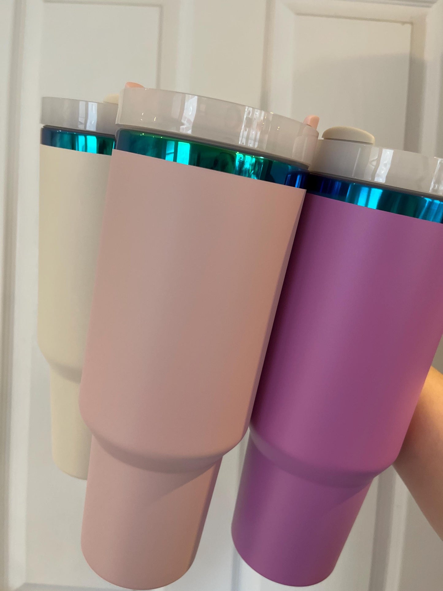 Three colorful tumblers held together against a white background