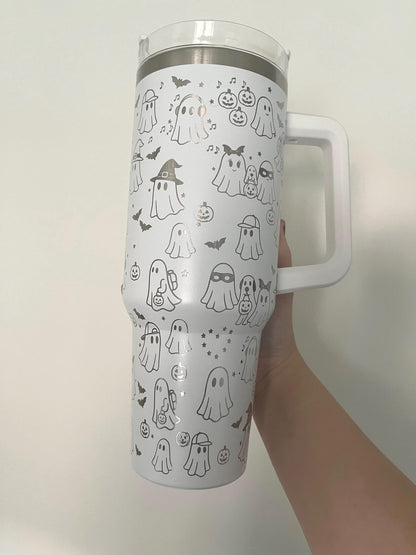 white 40oz tumbler with handle laser engraved with cute spooky sheet ghosts in costumes