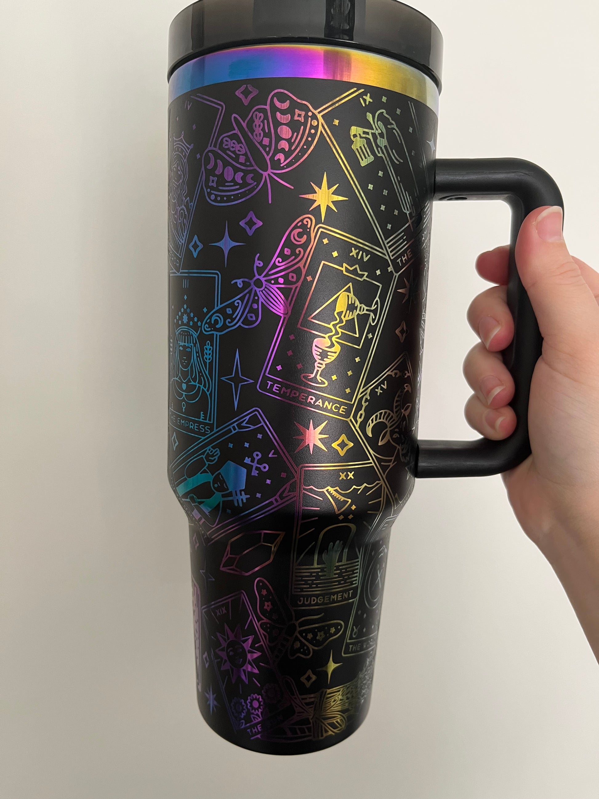 Laser engraved tarot card design on a black and black 40oz tumbler